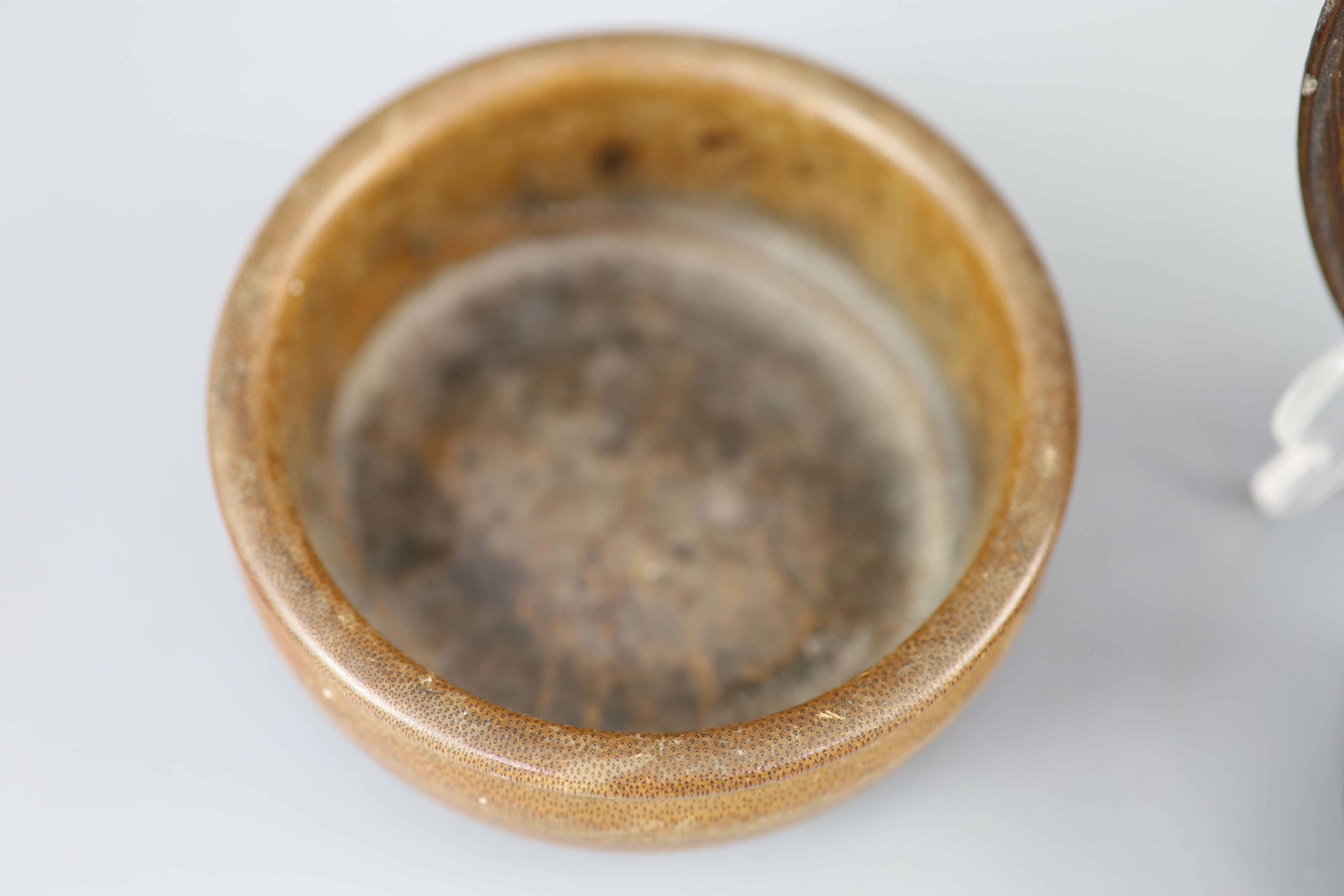 A Chinese carved bamboo cup, a plain bamboo brushwasher, 18th/19th century and a gilt decorated lacquer saucer dish, 17th century,